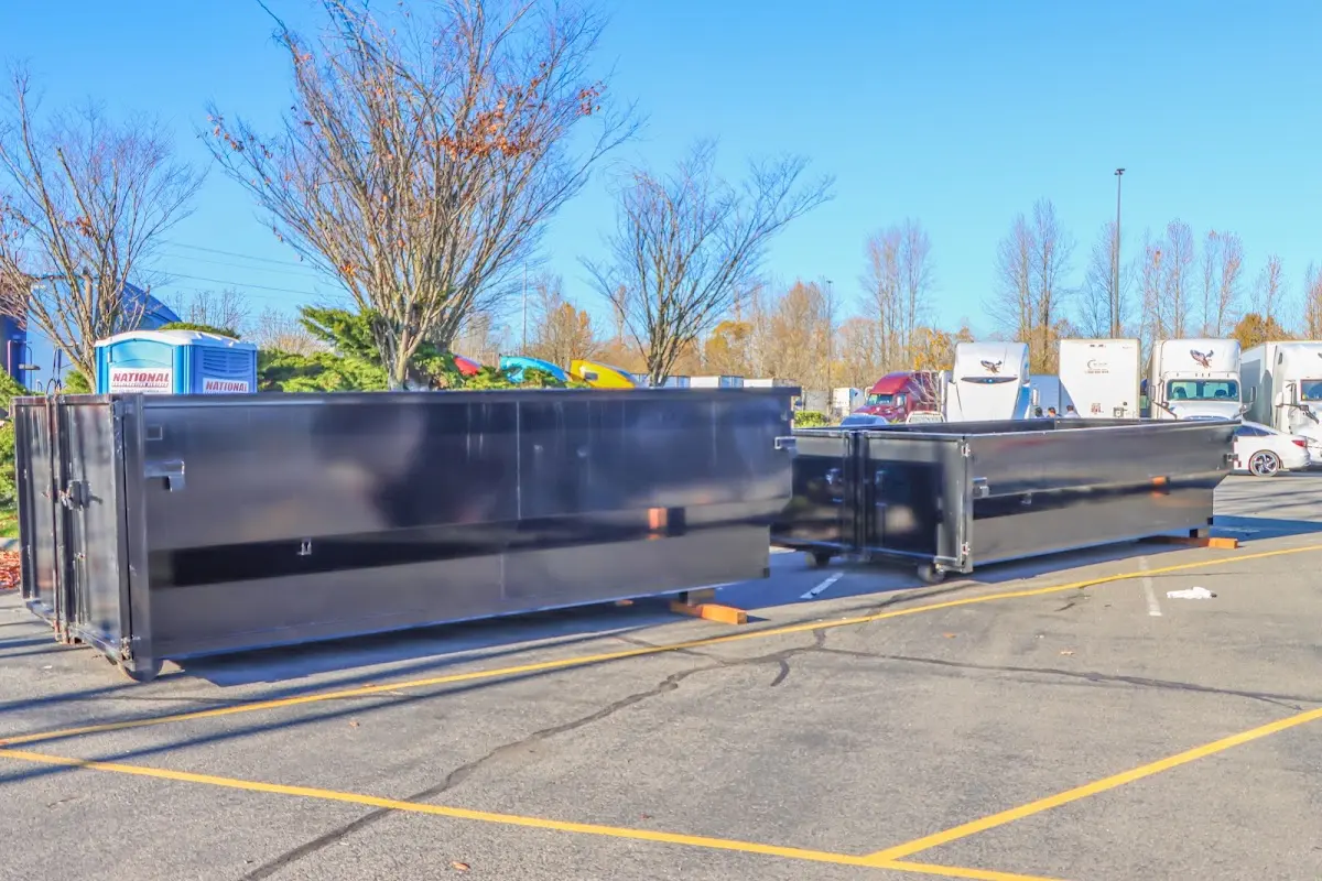 Professional dumpster rental service with roll-off container on residential driveway in Middleburg